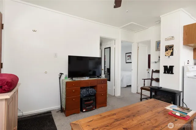 a bedroom with furniture and a flat screen tv