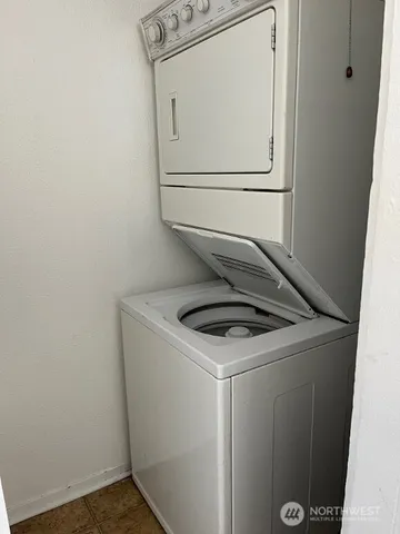 a kitchen with white cabinets and a stove top oven
