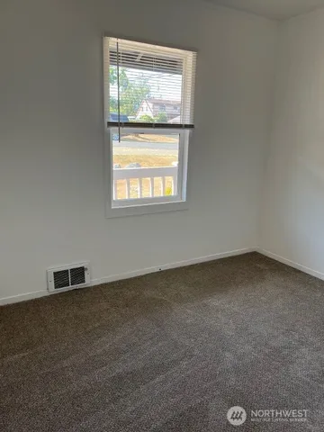 a view of walk in closet with empty racks