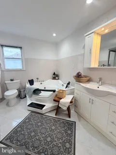 a living room with furniture a rug and white walls