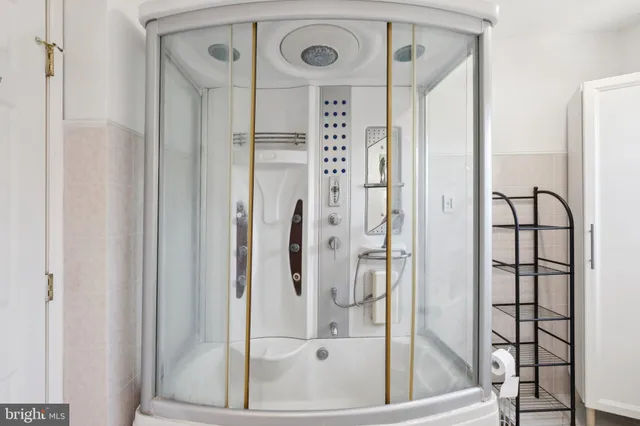 a bathroom with a bathtub and a shower