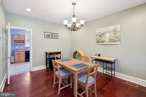 a view of a dining room with furniture wooden floor and a chandelier