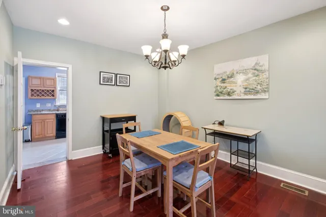 a view of a dining room with furniture wooden floor and a chandelier