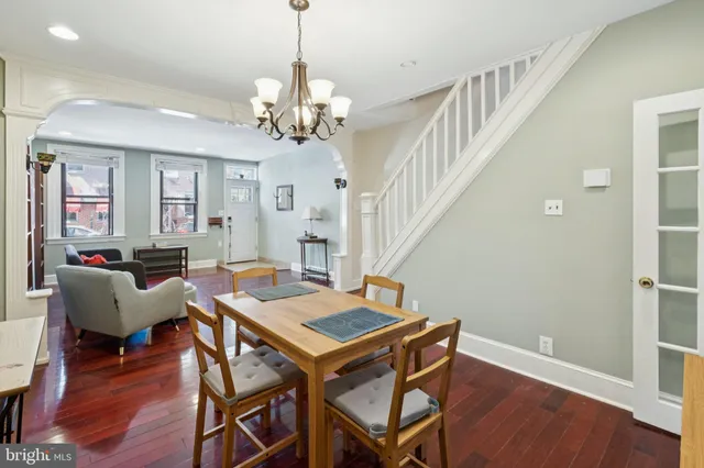 a view of a dining room with furniture wooden floor and chandelier