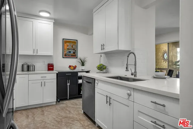 a kitchen with sink and cabinets