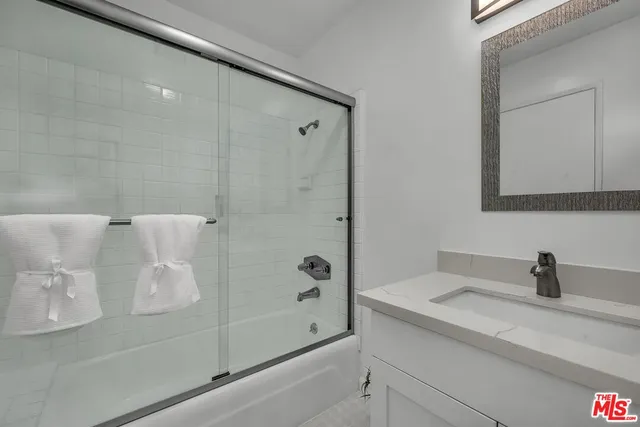 a bathroom with a shower and a sink