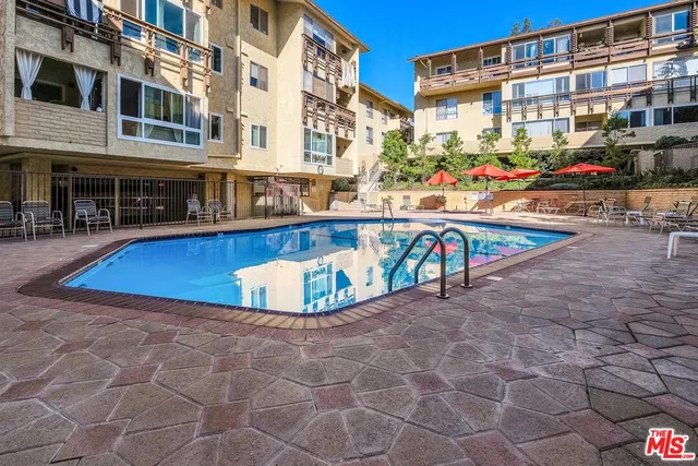 a view of a swimming pool with outdoor seating