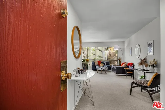 a view of a livingroom with furniture and a window