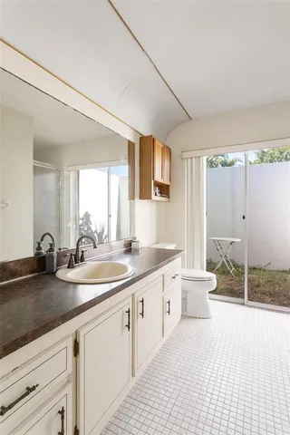 a spacious bathroom with a double vanity sink and a mirror