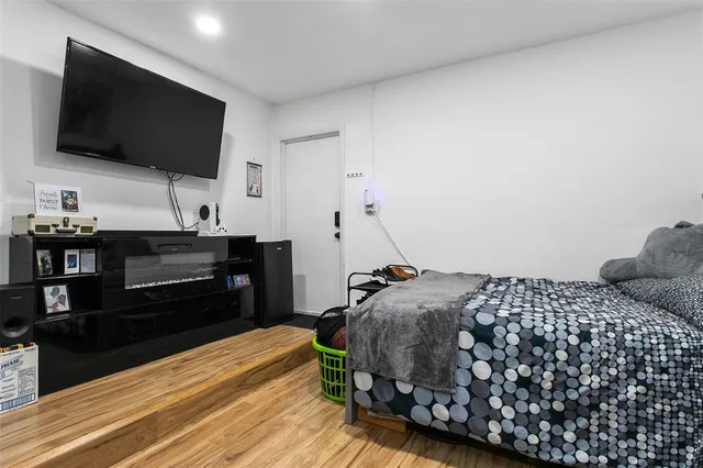 a bedroom with a bed and a flat screen tv