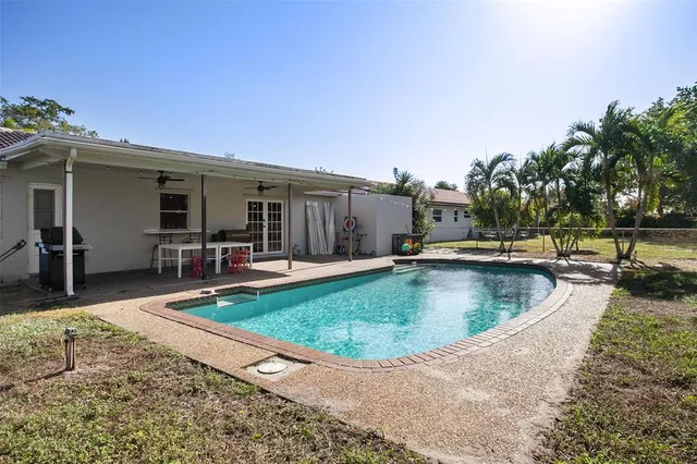 a view of a house with swimming pool and sitting area