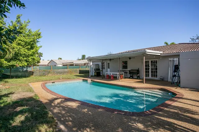 a view of a house with swimming pool and a yard