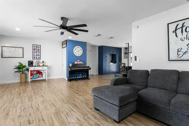 a living room with furniture and a wooden floor