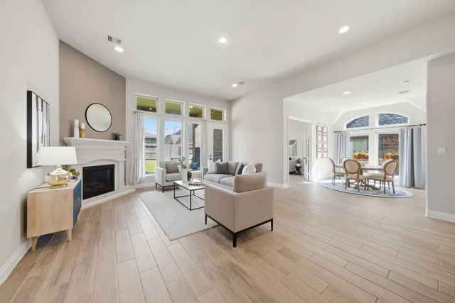 a living room with furniture a fireplace and a large window