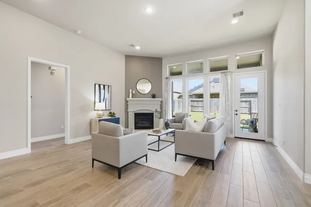 a living room with furniture wooden floor and a fireplace