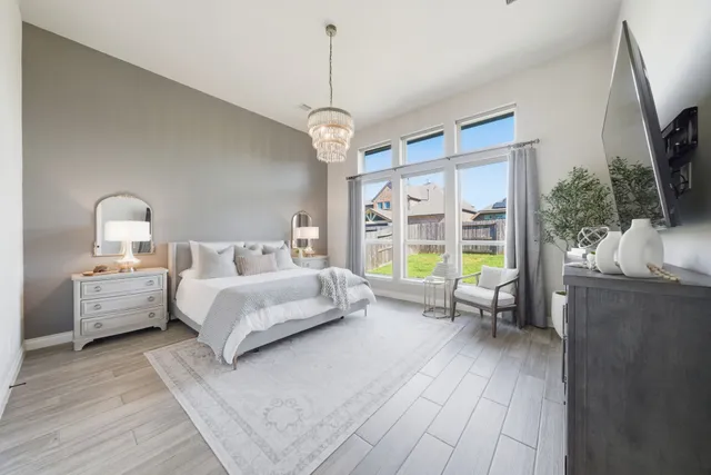 a bed room with a bed and a chandelier