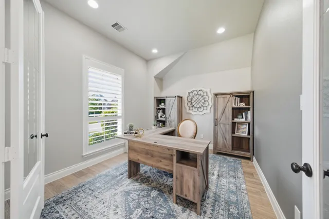 a living room with furniture a rug and a window