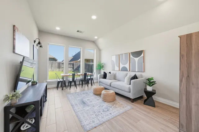 a living room with furniture and a table