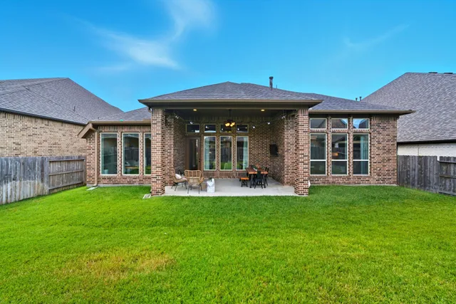 a view of a house with a yard and sitting area