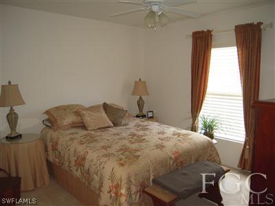 17187 Malaga Road Fort Myers, FL 33967 - Photo 8 of 9 a bedroom with a bed and a window