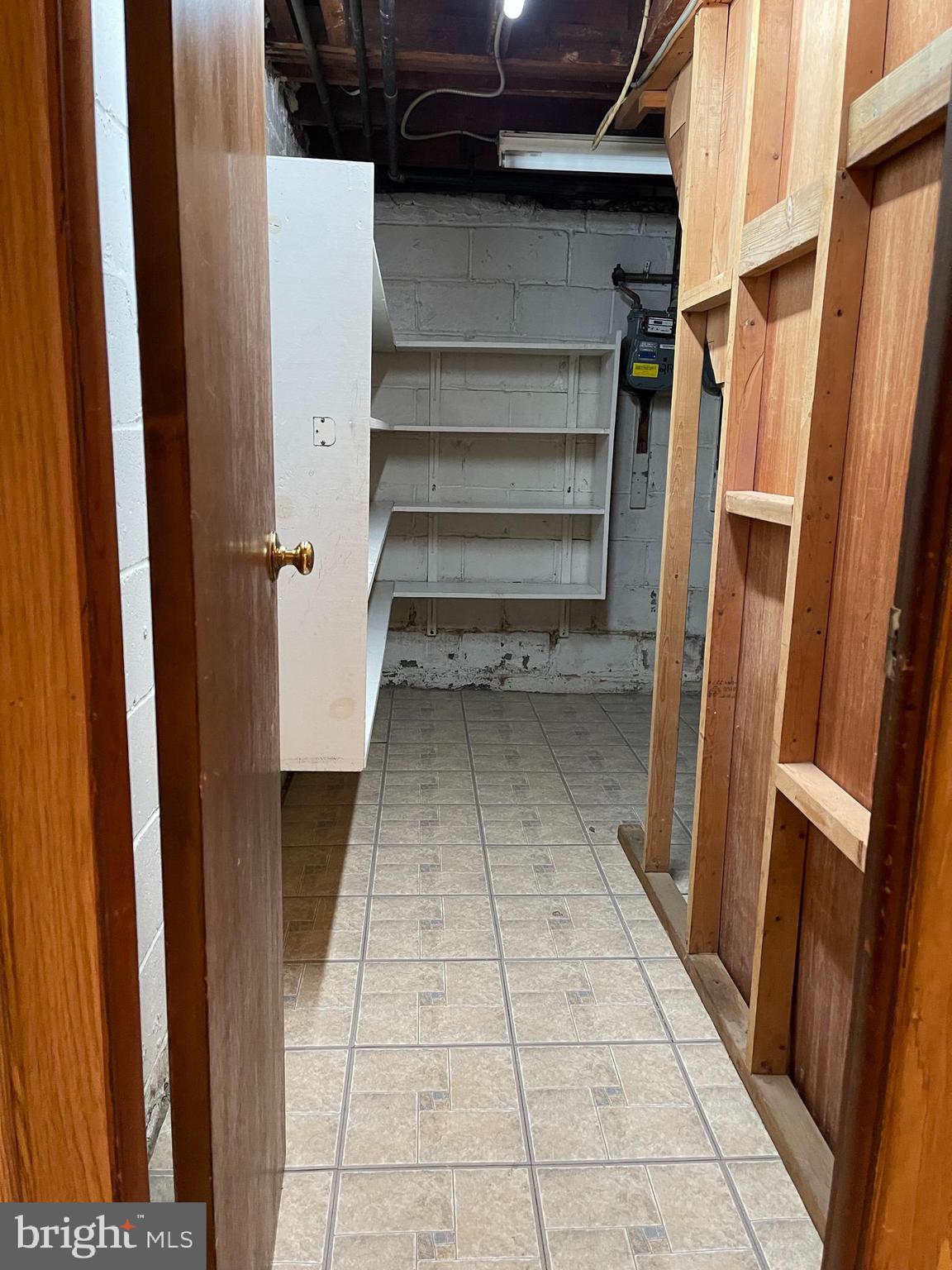 4901 Brookwood Road Baltimore, MD 21225 - Photo 35 of 39 Basement storage area with shelving