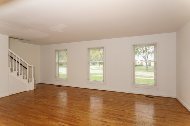 4201 Cumnor Road Downers Grove, IL 60515 - Photo 2 of 10 a view of an empty room with wooden floor and a window