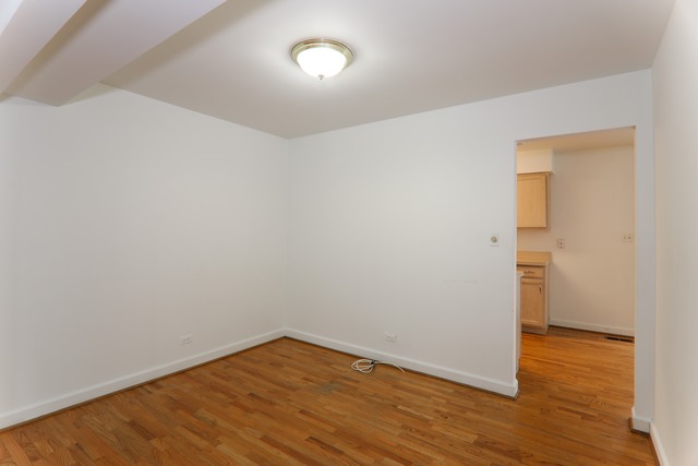 4201 Cumnor Road Downers Grove, IL 60515 - Photo 3 of 10 a view of an empty room with wooden floor and a window