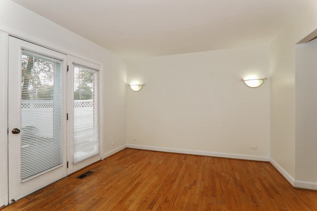 4201 Cumnor Road Downers Grove, IL 60515 - Photo 6 of 10 an empty room with wooden floor and windows