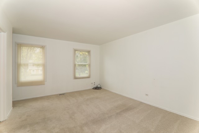 4201 Cumnor Road Downers Grove, IL 60515 - Photo 7 of 10 an empty room with windows