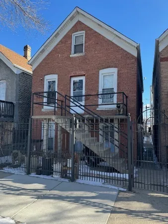 a front view of house with a garden