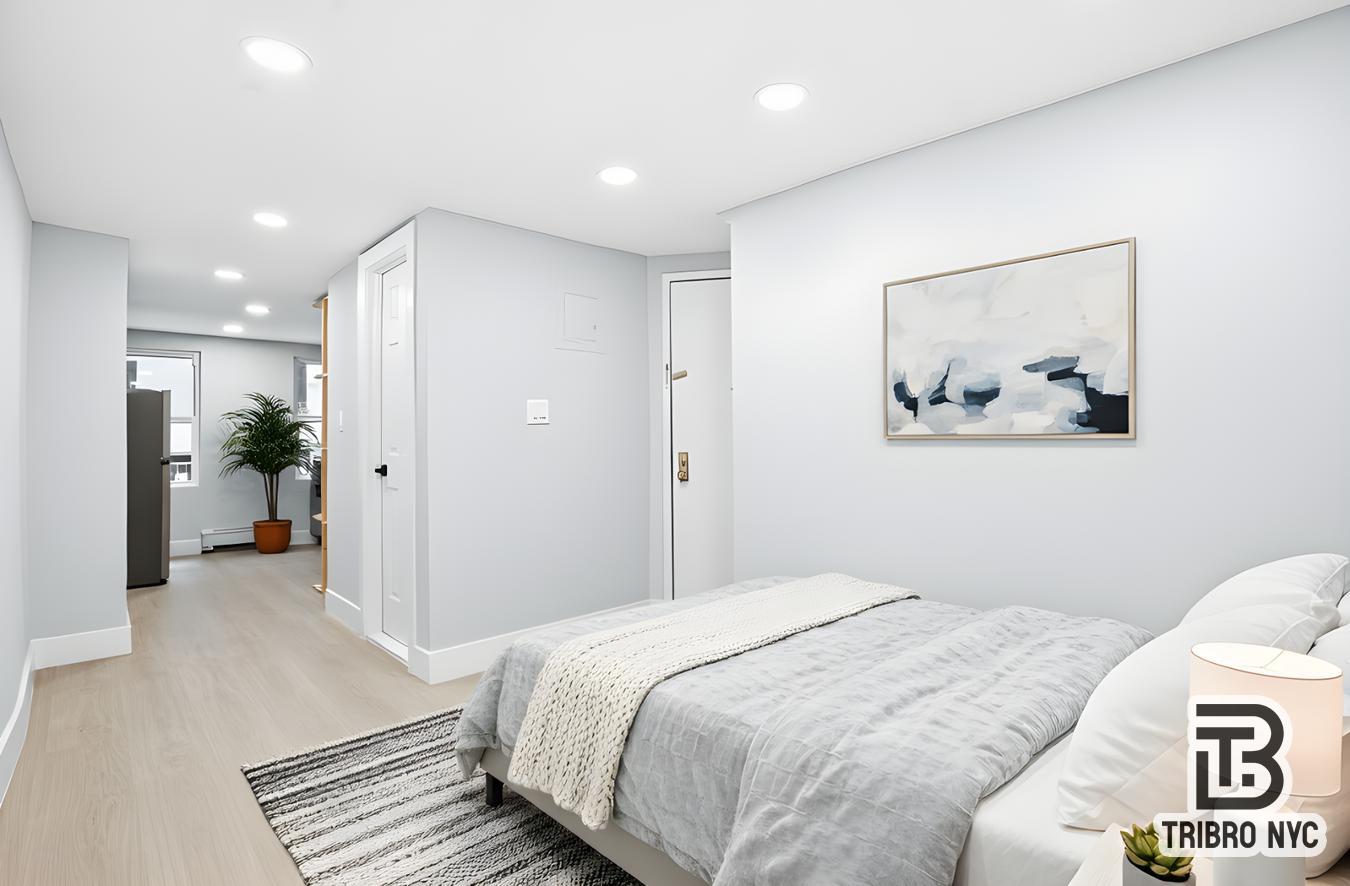 a bedroom with a bed and a painting on the wall