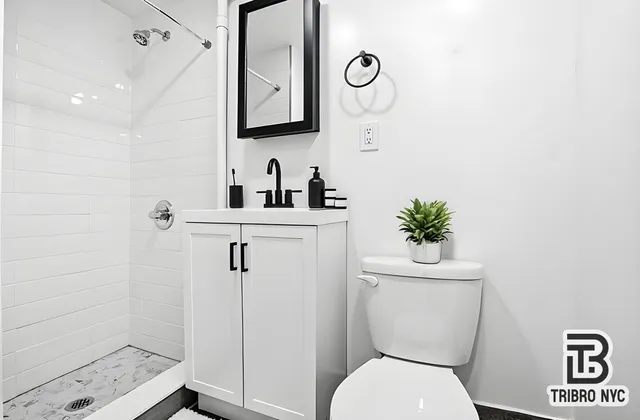 a bathroom with a toilet sink and shower