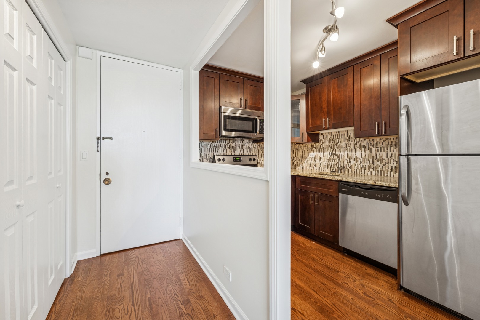 Undisclosed Address Chicago, IL 60613 - Photo 2 of 15 a kitchen with stainless steel appliances granite countertop a refrigerator and a stove