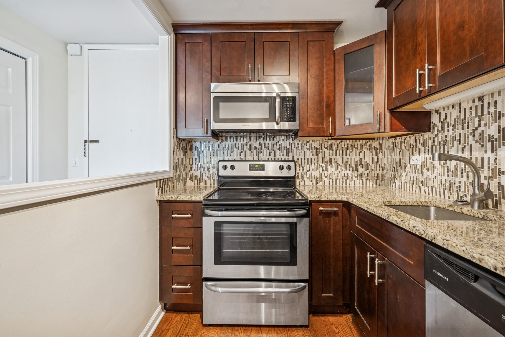 Undisclosed Address Chicago, IL 60613 - Photo 4 of 15 a kitchen with a stove and a sink
