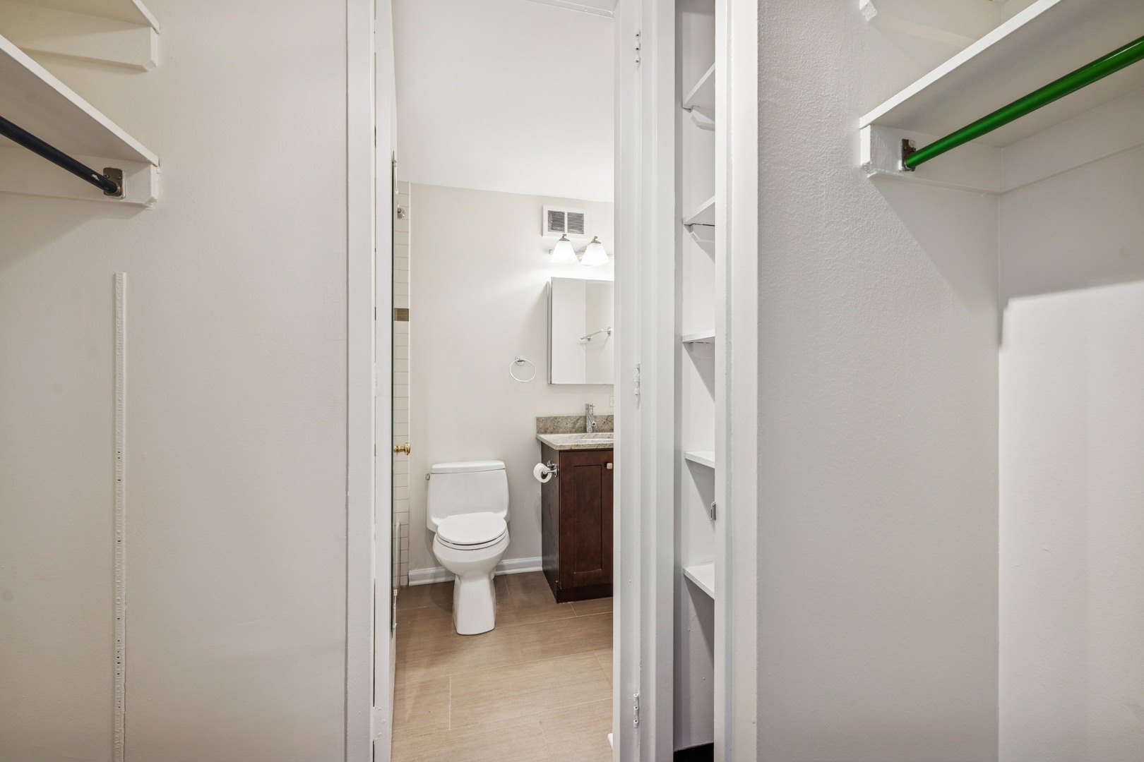 Undisclosed Address Chicago, IL 60613 - Photo 5 of 15 a bathroom with a granite countertop toilet and a shower