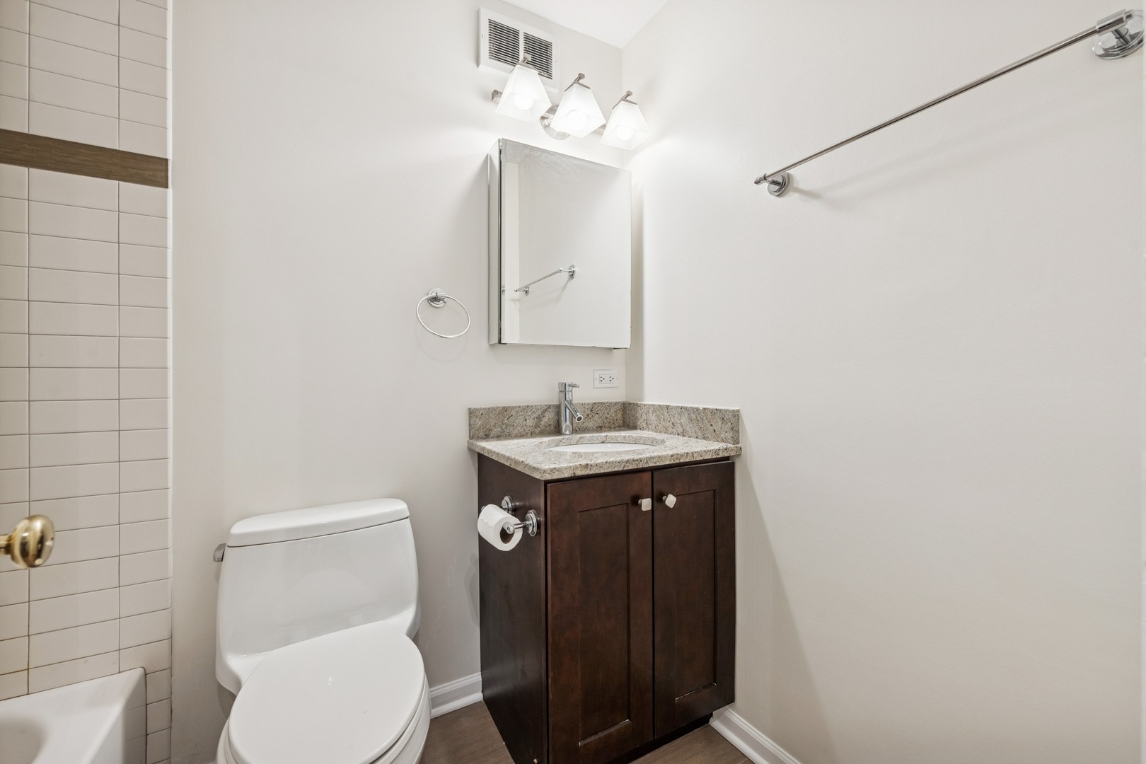 Undisclosed Address Chicago, IL 60613 - Photo 6 of 15 a bathroom with a toilet sink and mirror