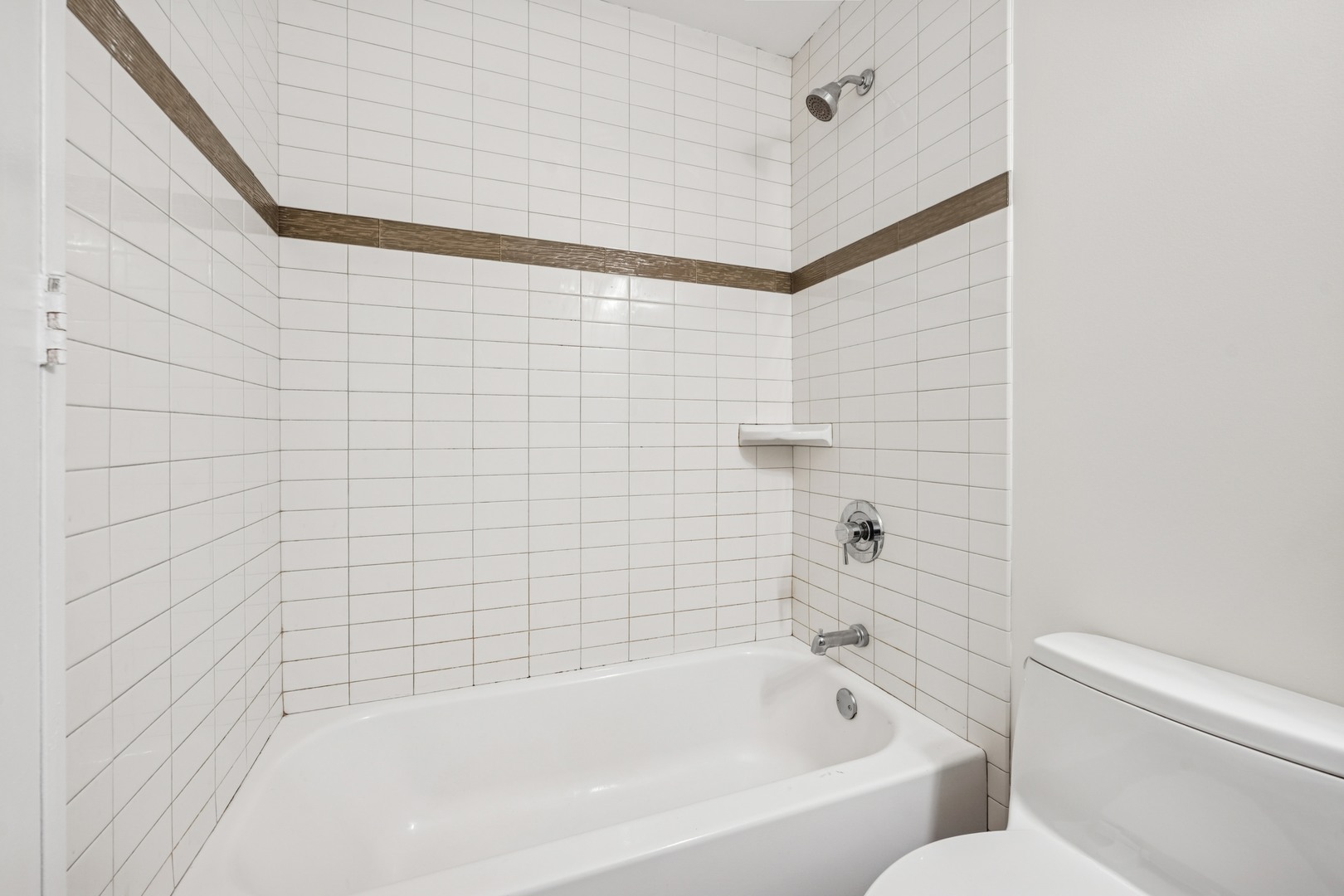 Undisclosed Address Chicago, IL 60613 - Photo 7 of 15 a bathroom with a bathtub and shower