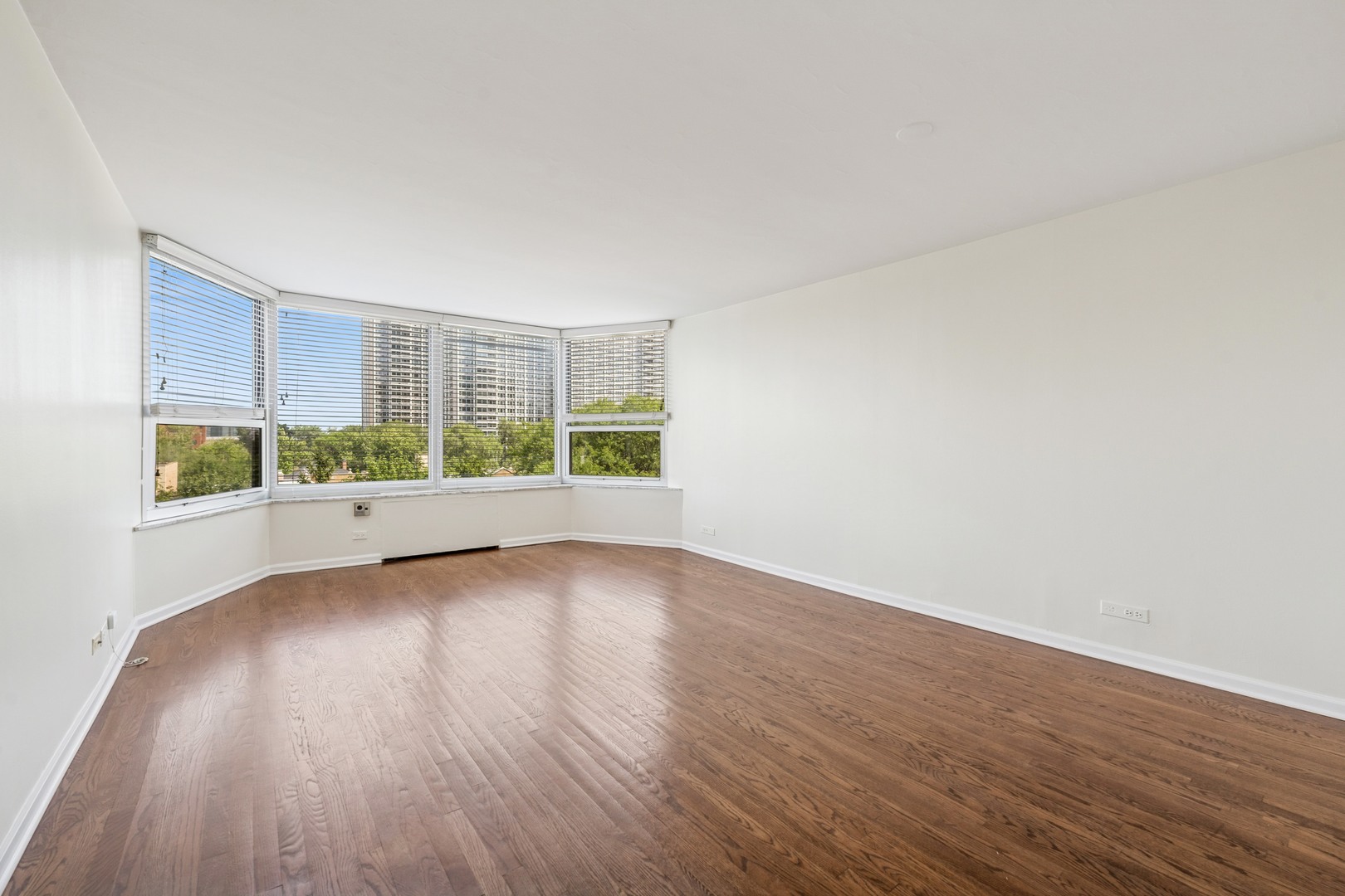 Undisclosed Address Chicago, IL 60613 - Photo 8 of 15 a view of an empty room with wooden floor and a window