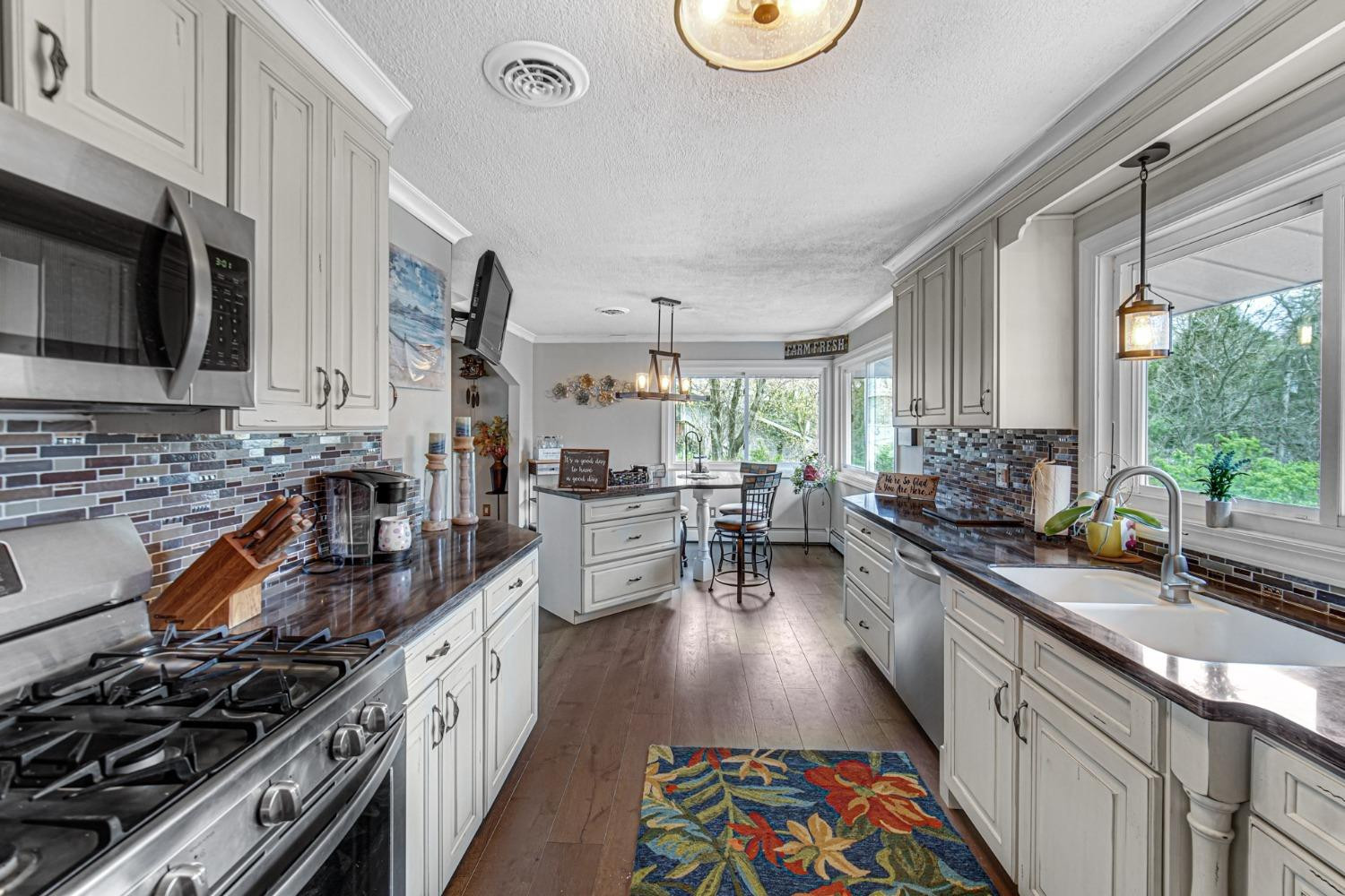 42 Ogden Road Portage, IN 46368 - Photo 20 of 40 a kitchen with stainless steel appliances a sink a stove and a window