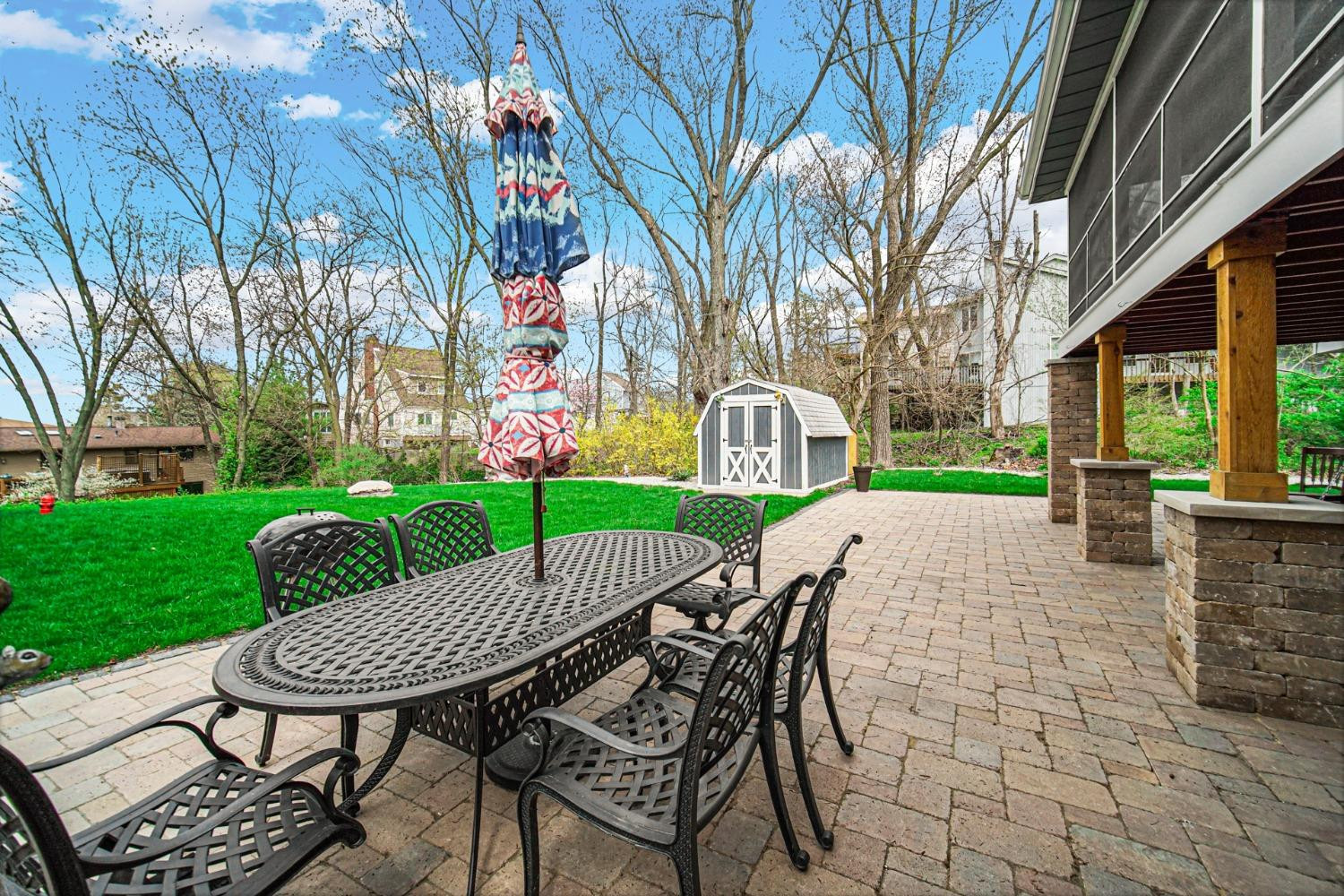 42 Ogden Road Portage, IN 46368 - Photo 33 of 40 a view of a patio with table and chairs and a barbeque with potted plants