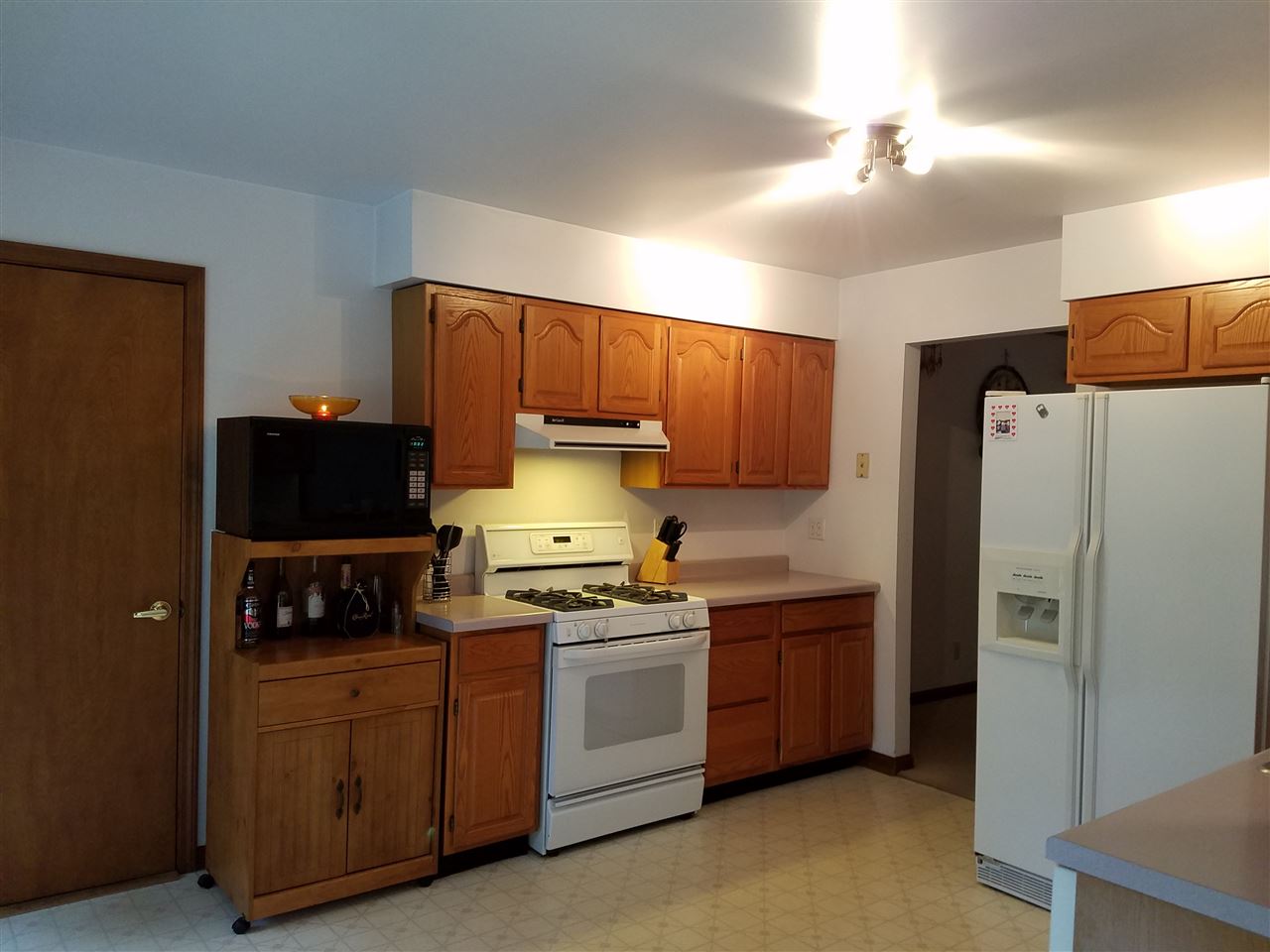 3224 South Seldom Scene Road Oregon, IL 61061 - Photo 5 of 17 a kitchen with stainless steel appliances a refrigerator sink and cabinets
