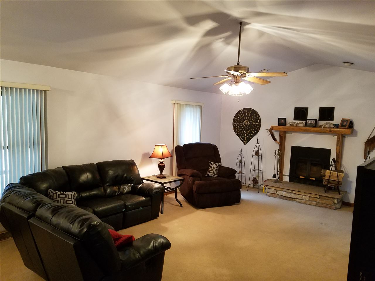 3224 South Seldom Scene Road Oregon, IL 61061 - Photo 6 of 17 a living room with furniture a fireplace and a chandelier