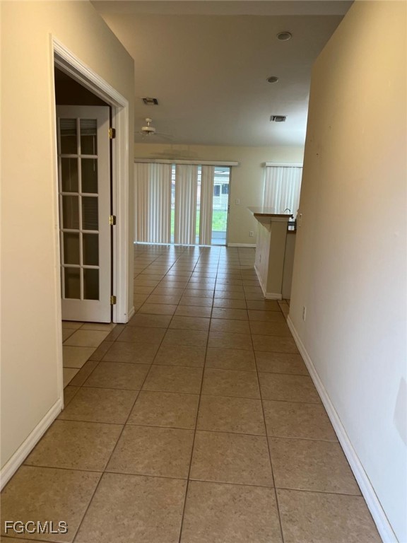 2923 3rd Street Southwest Lehigh Acres, FL 33976 - Photo 4 of 19 a view of a hallway with wooden floor and a living room