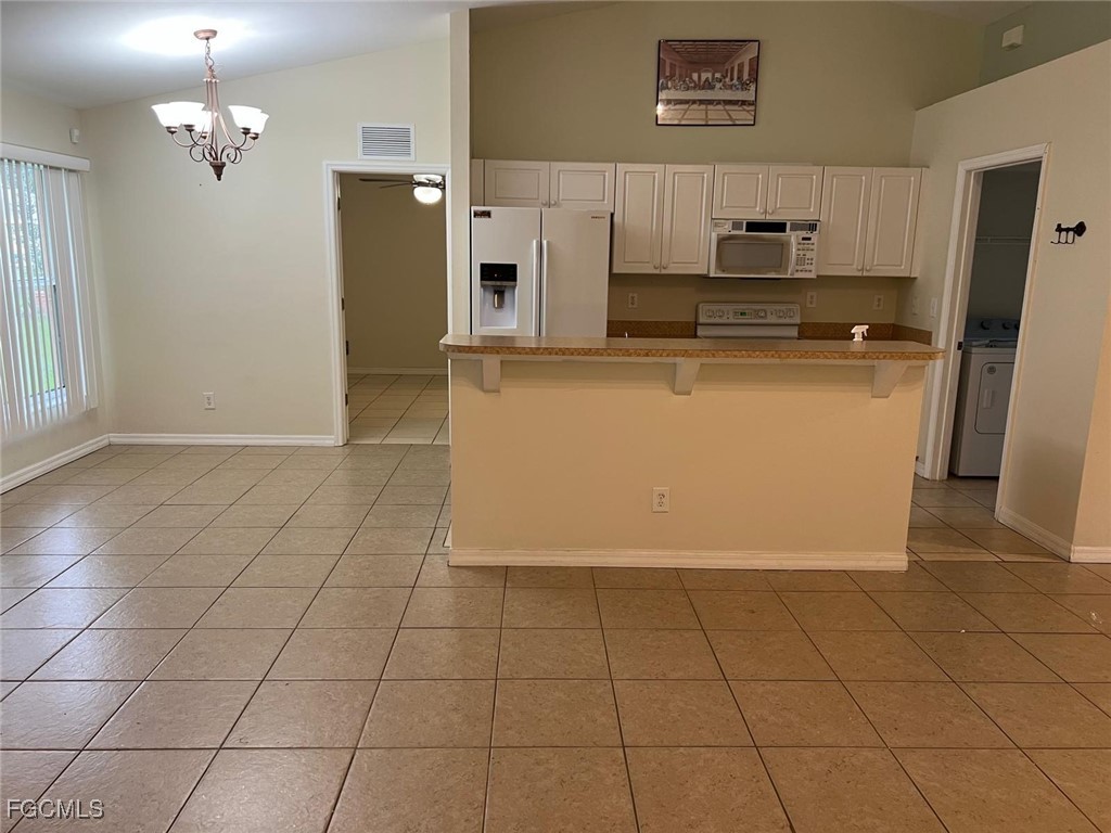 2923 3rd Street Southwest Lehigh Acres, FL 33976 - Photo 6 of 19 a kitchen with stainless steel appliances a refrigerator sink and cabinets
