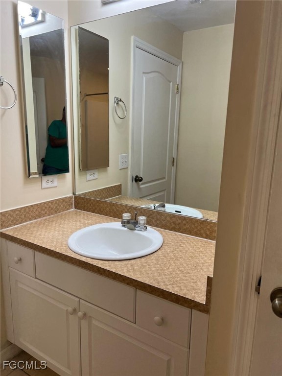 2923 3rd Street Southwest Lehigh Acres, FL 33976 - Photo 8 of 19 a bathroom with a granite countertop sink and a mirror