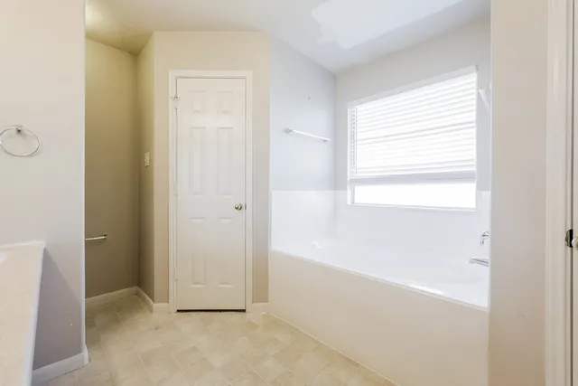 a spacious bathroom with a tub sink and shower
