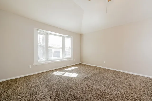 a view of a livingroom with a chandelier fan