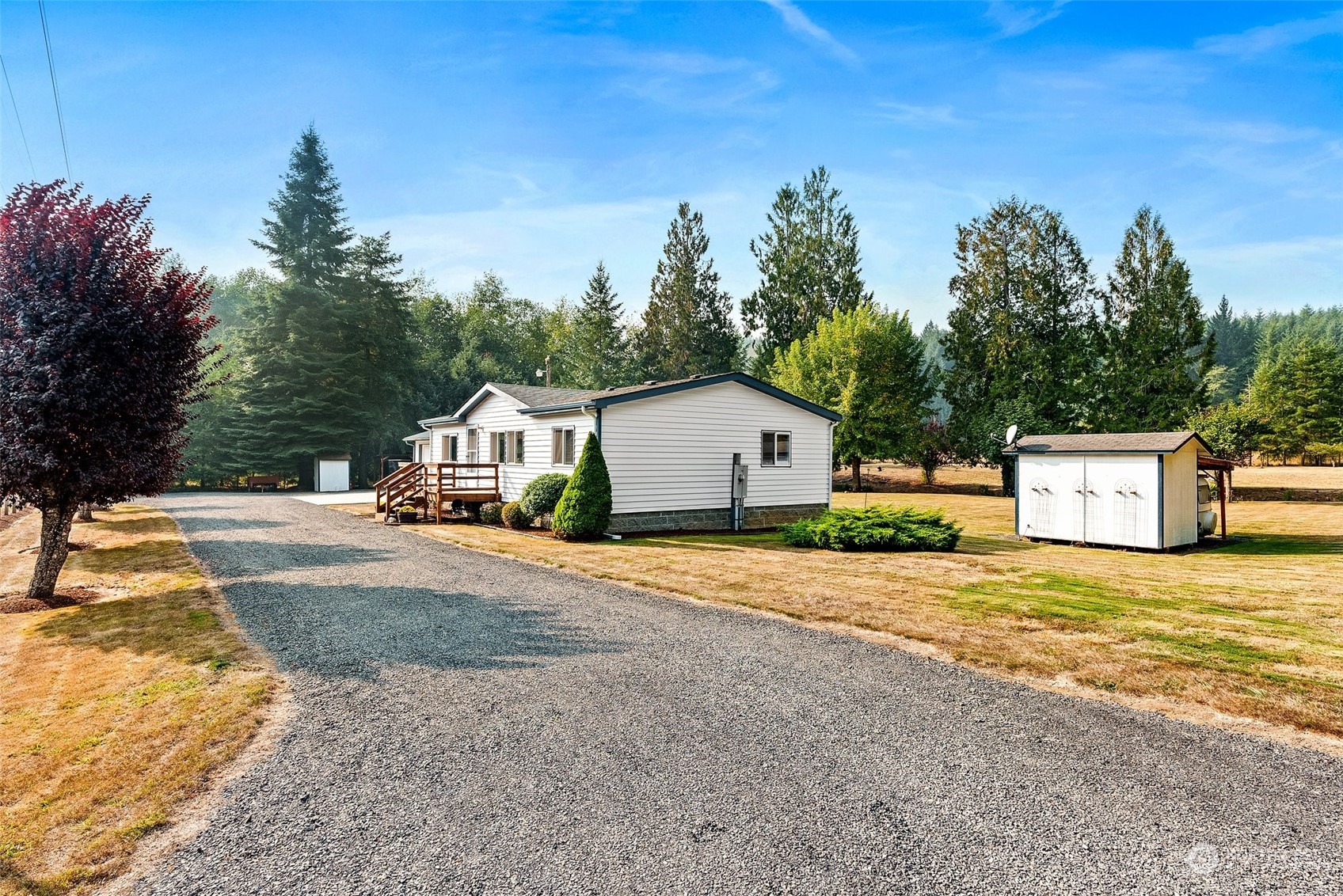 824 Winlock-Vader Road Winlock, WA 98596 - Photo 3 of 36 a front view of a house with a yard and garage