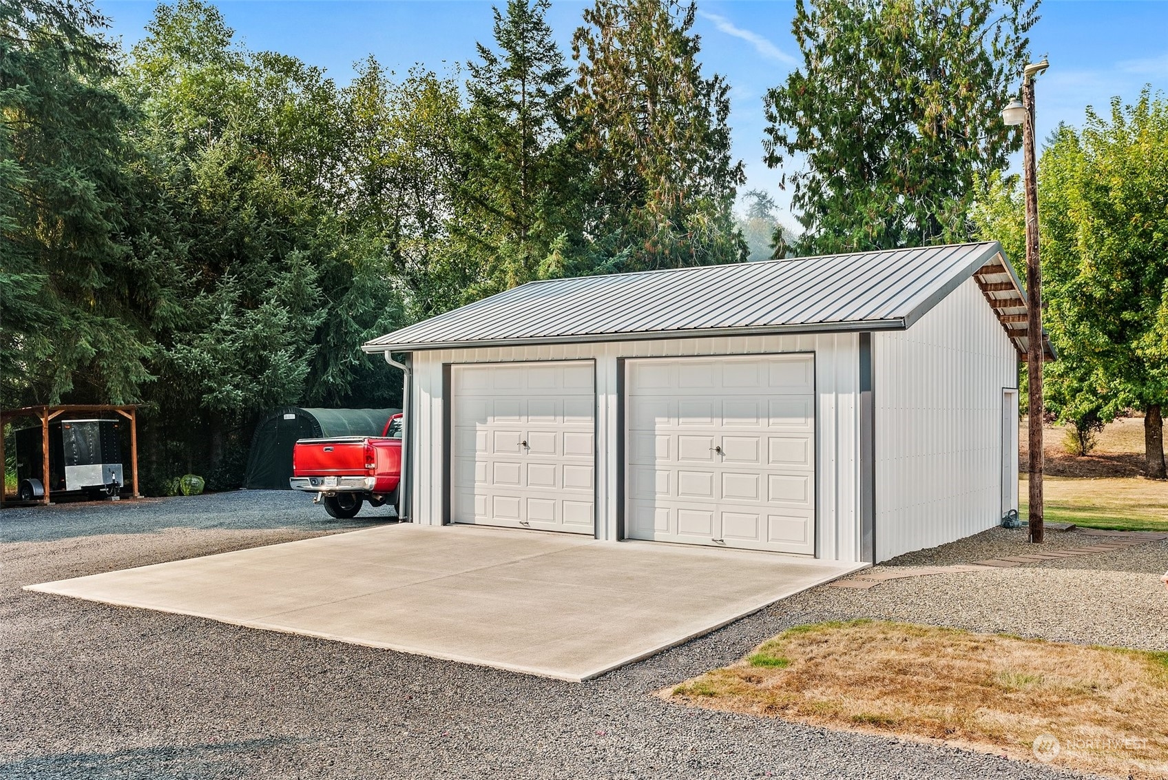 824 Winlock-Vader Road Winlock, WA 98596 - Photo 9 of 36 a view of a house with a garage and yard