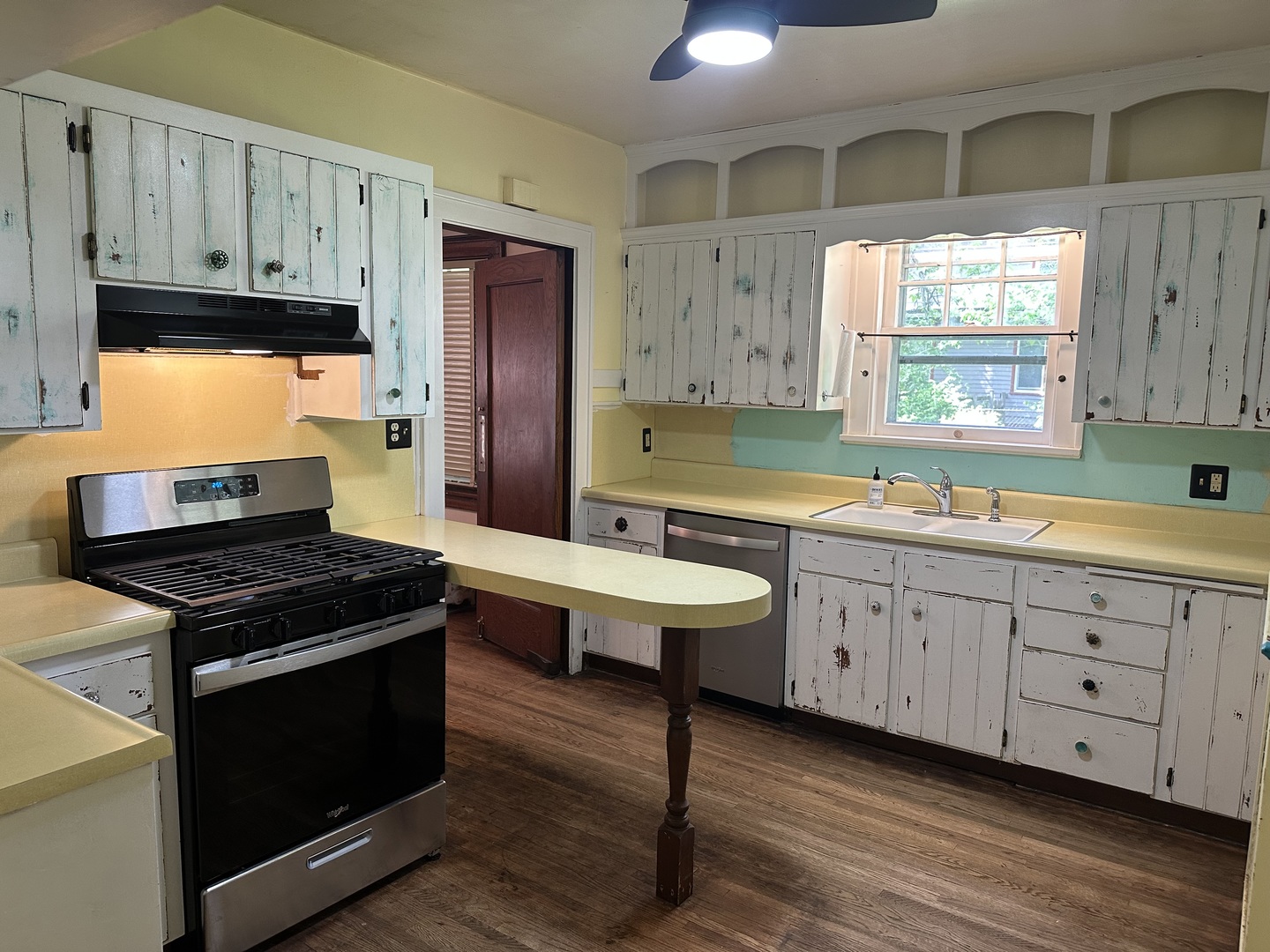 1418 North Sheridan Road Peoria, IL 61606 - Photo 6 of 34 a kitchen with wooden cabinets and a stove top oven